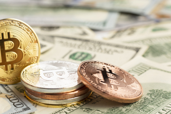 bitcoin-pile-top-dolar-bills-1.jpg